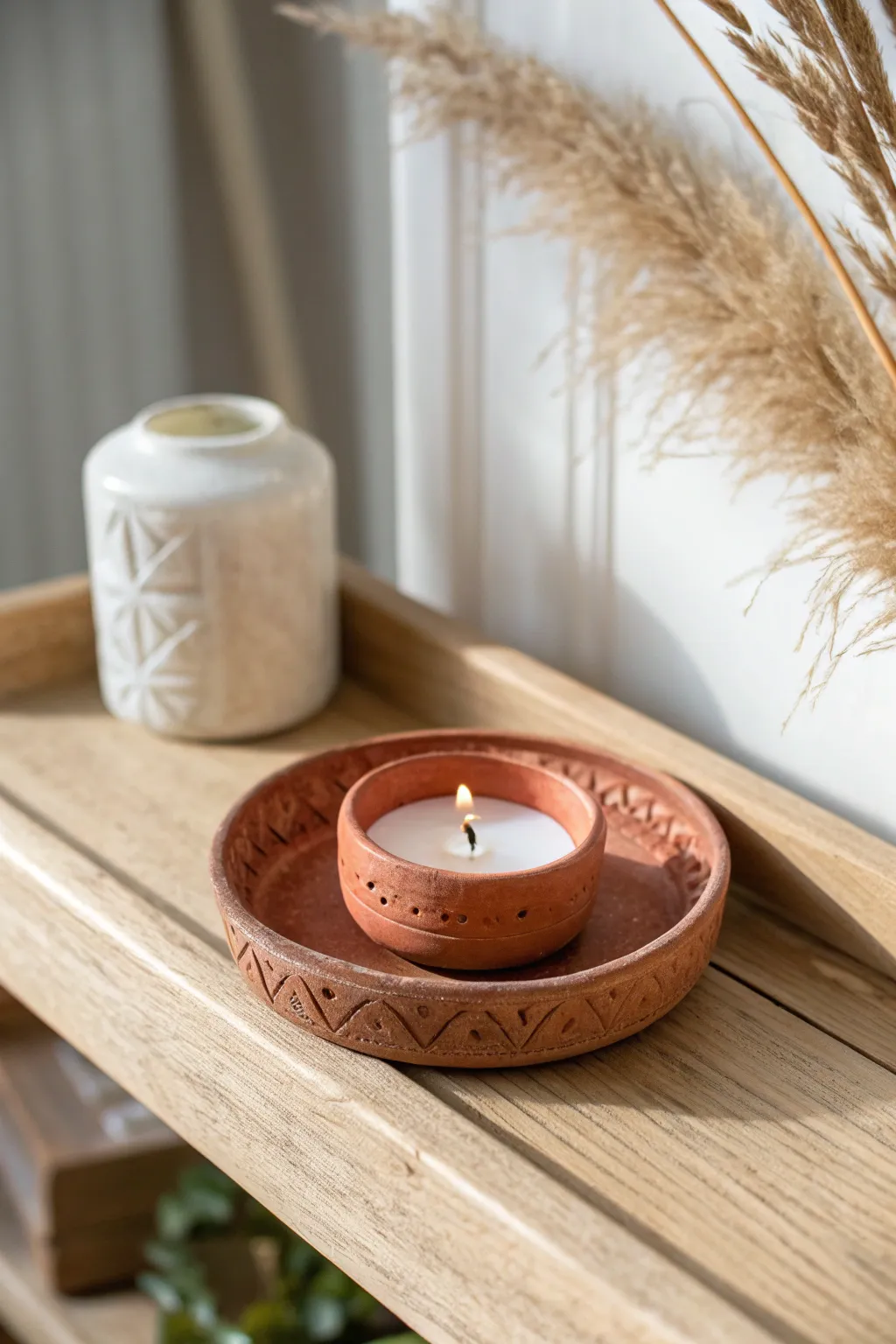 Mini clay candle holder dish with simple carved lines, cozy minimal style and warm contrast