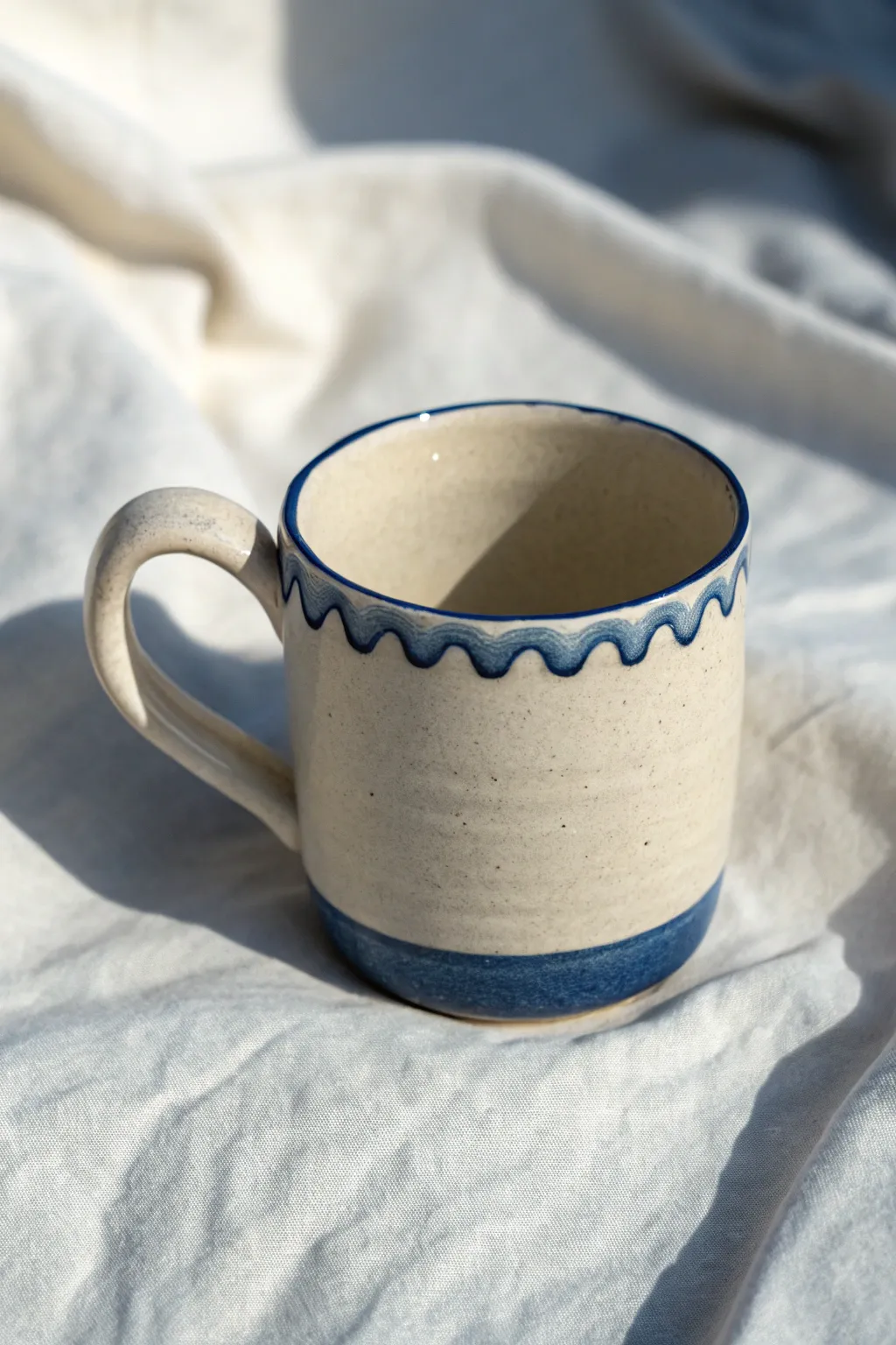 Wavy rim slab mug in bold cobalt glaze, minimalist and handmade for cozy morning rituals.