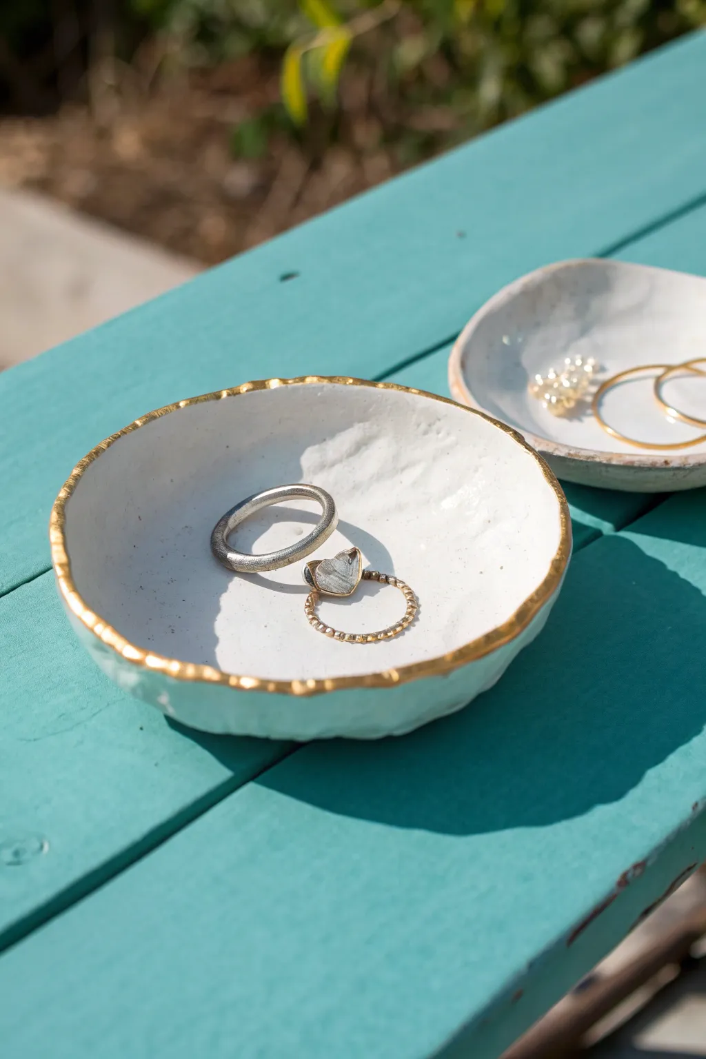 White clay trinket dish with a delicate gold rim, styled simply for a chic vanity moment.