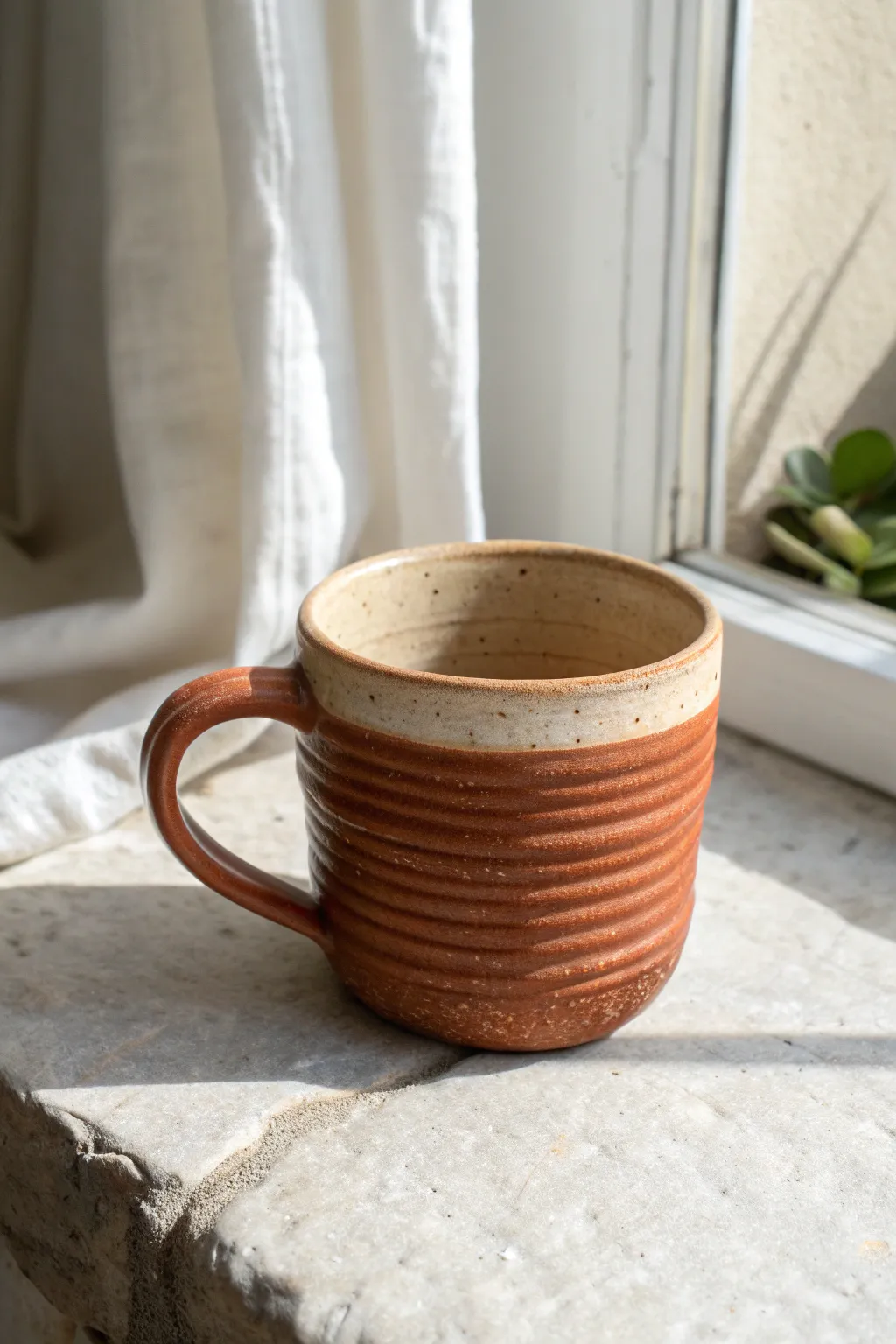 Chunky coil pinch mug with a strap handle, matte terracotta glaze, and cozy handmade charm.