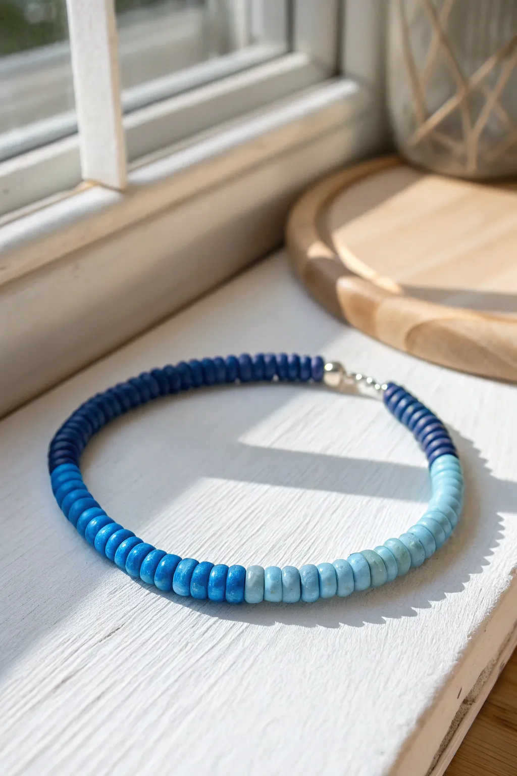 Monochrome ombre heishi bracelet in blues, from deep indigo to airy sky for minimalist boho style.