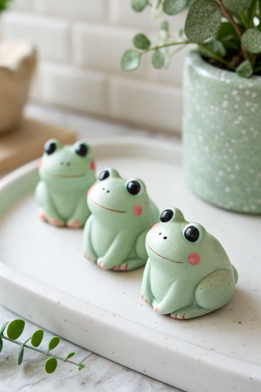 Three mini frog blob figurines in soft greens with rosy cheeks, simple, cute, and beginner-friendly.