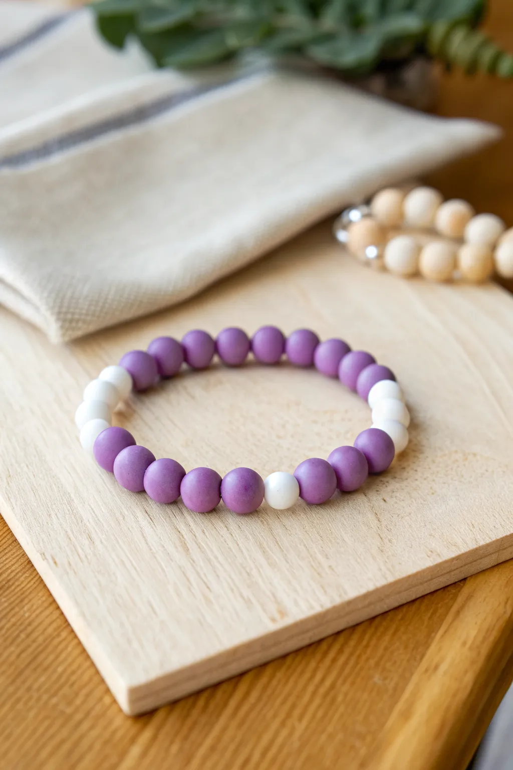 Sweet purple-and-white clay bead bracelet with a clean alternating pattern and a soft boho vibe.