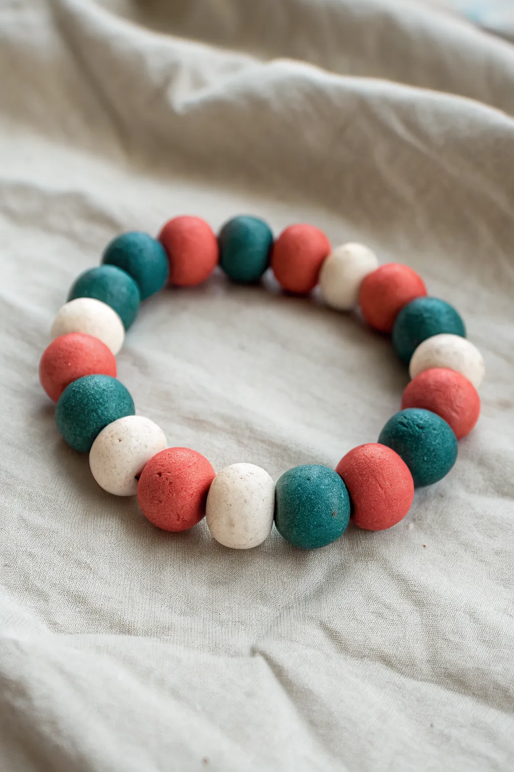 Bold color-block clay bead bracelet in teal, coral and white, minimalist boho DIY inspo