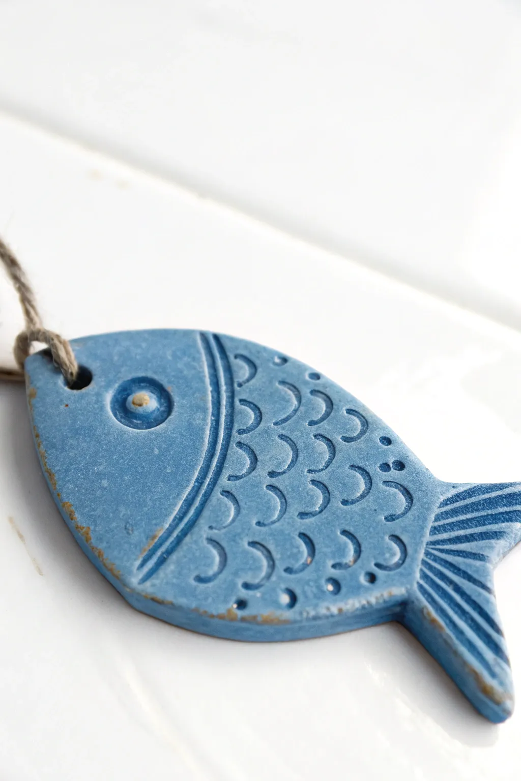 Simple stamped blue clay fish with easy scales, clean minimal styling, and bold contrast.