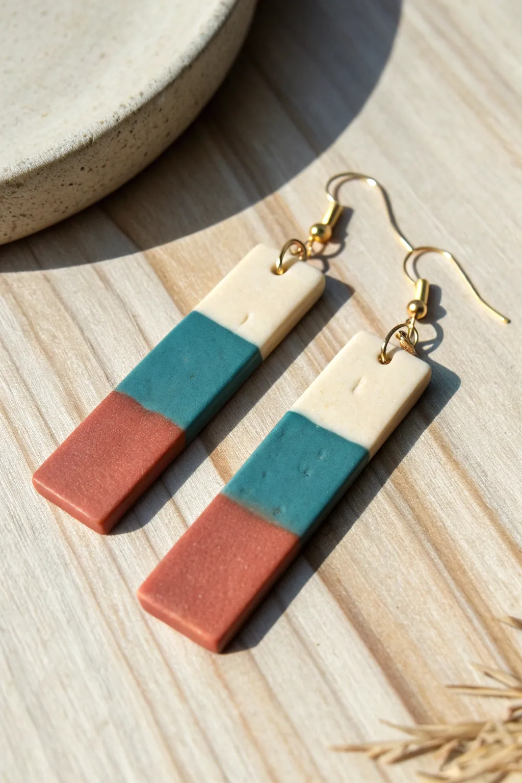 Minimal color-block polymer clay rectangle earrings in terracotta, cream, and teal.