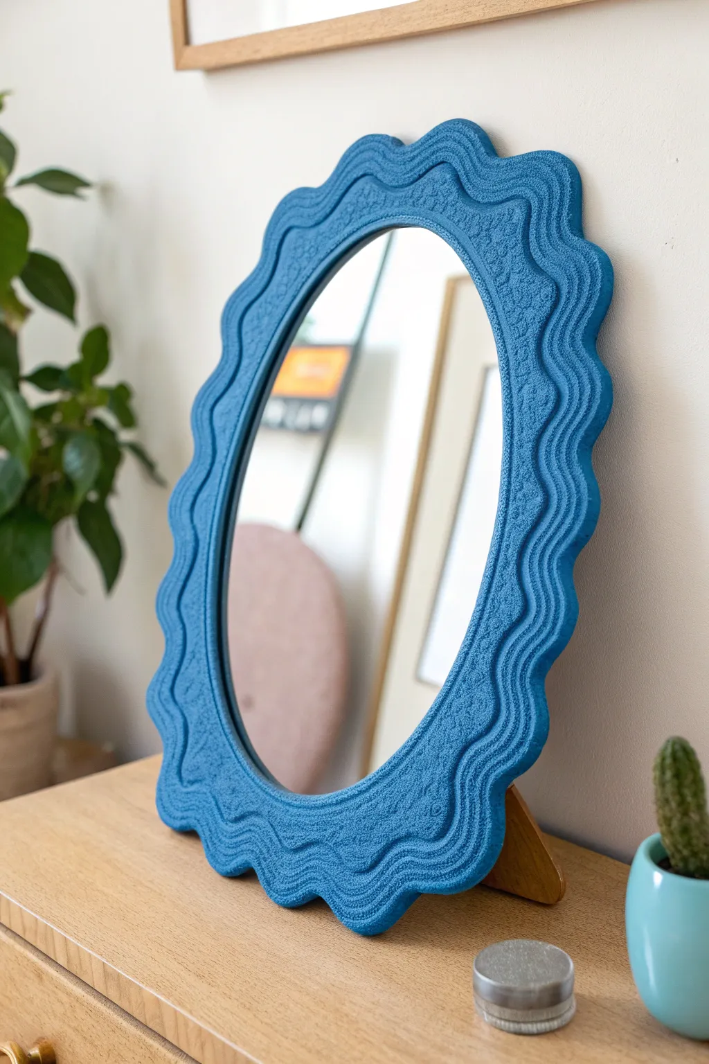 Wavy blob foam clay mirror frame in bold color, minimalist styling for a modern boho nook.