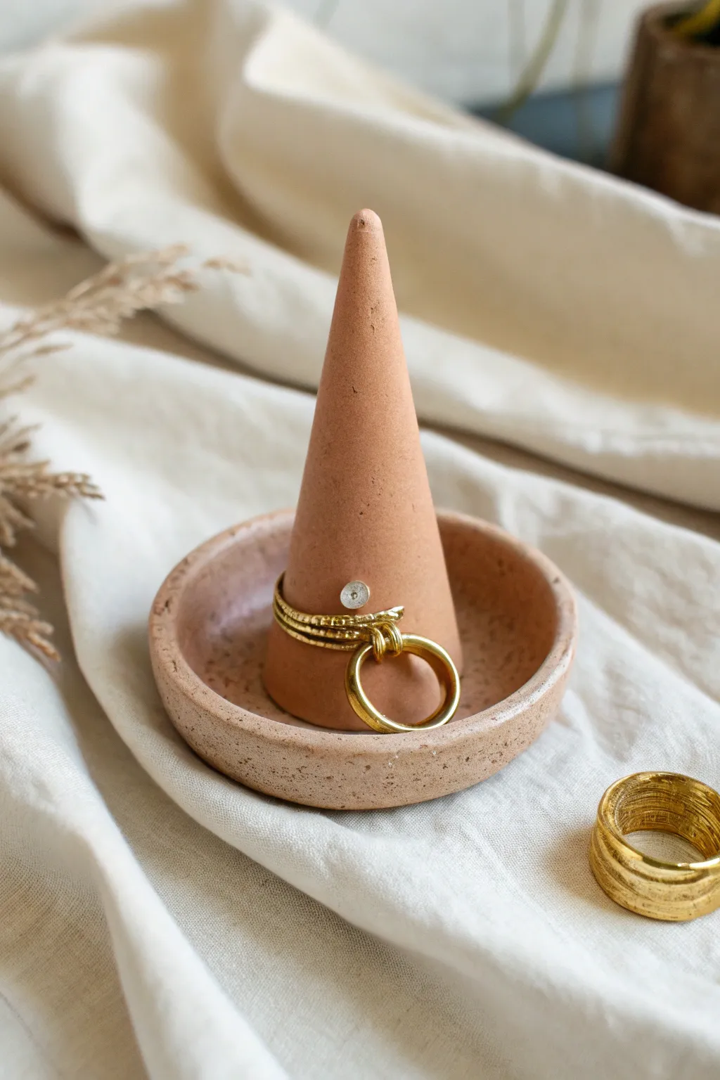 Minimal hand-molded ring cone holder in bold terracotta, simple, elegant, and easy to DIY