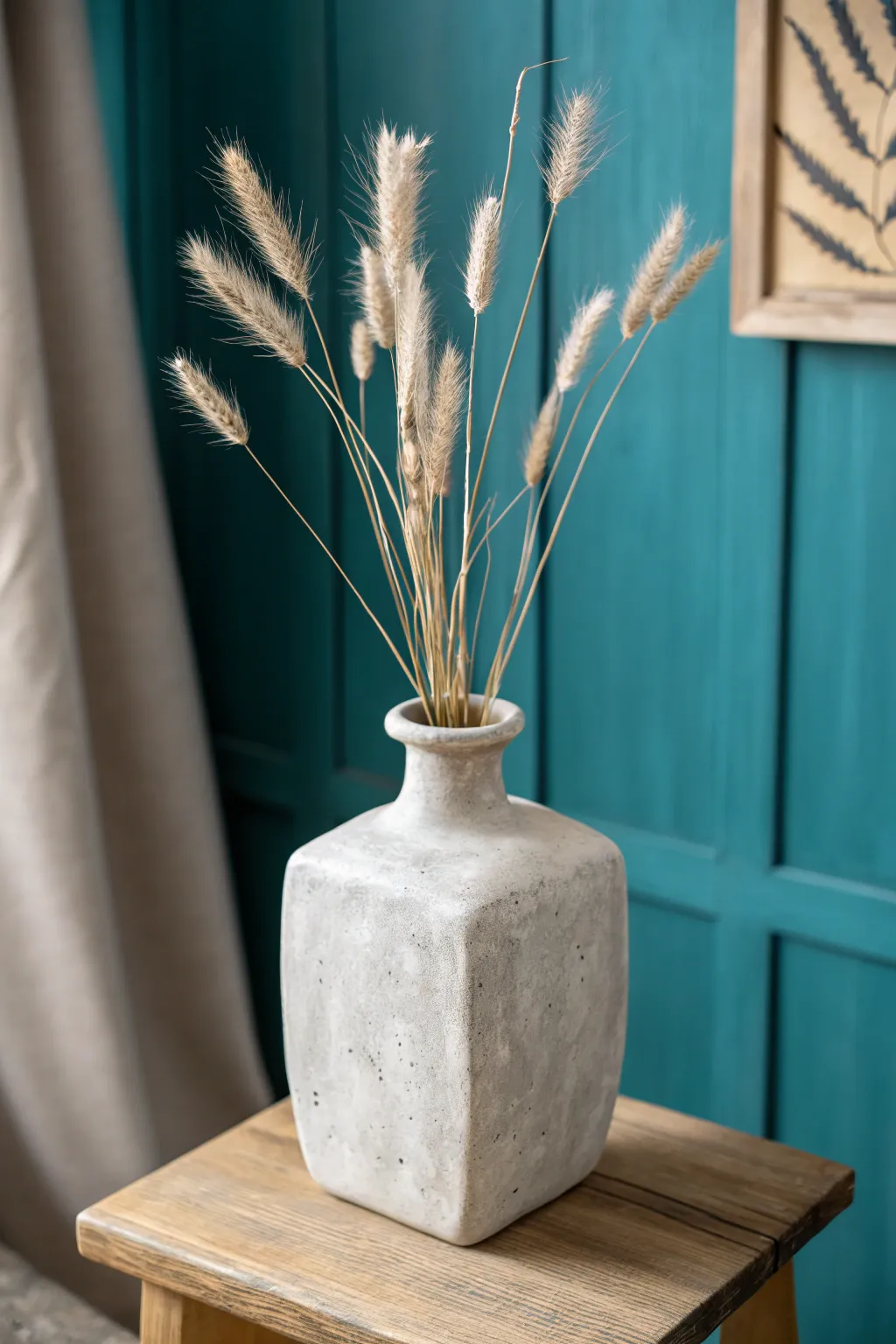 Crisp-edged slab-built square vase in soft neutral clay, styled with airy dried botanicals.