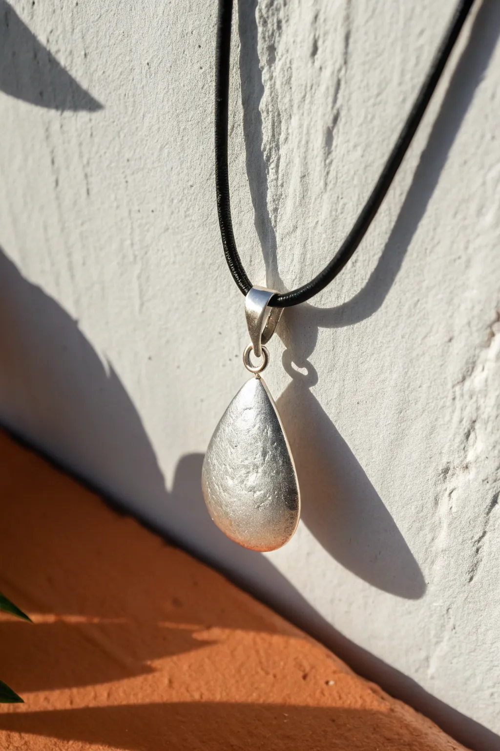 Polished metal clay teardrop pendant with a built-in bail, minimalist and boho on a simple cord.