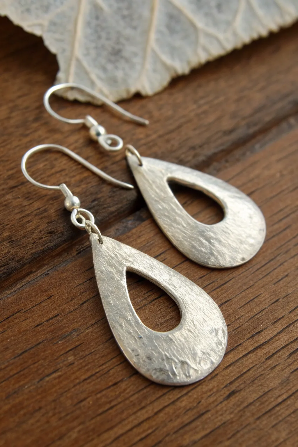 Organic teardrop metal clay dangles with simple cutouts and a softly hammered finish