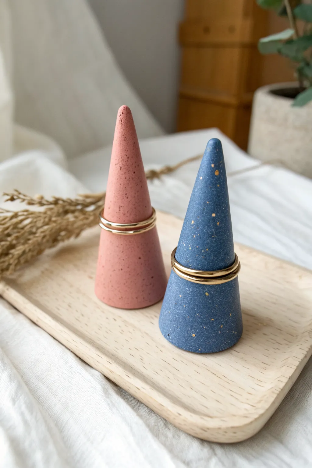 Tiny matching clay ring cones in bold blush and cobalt, a sweet mini date-night pottery project.