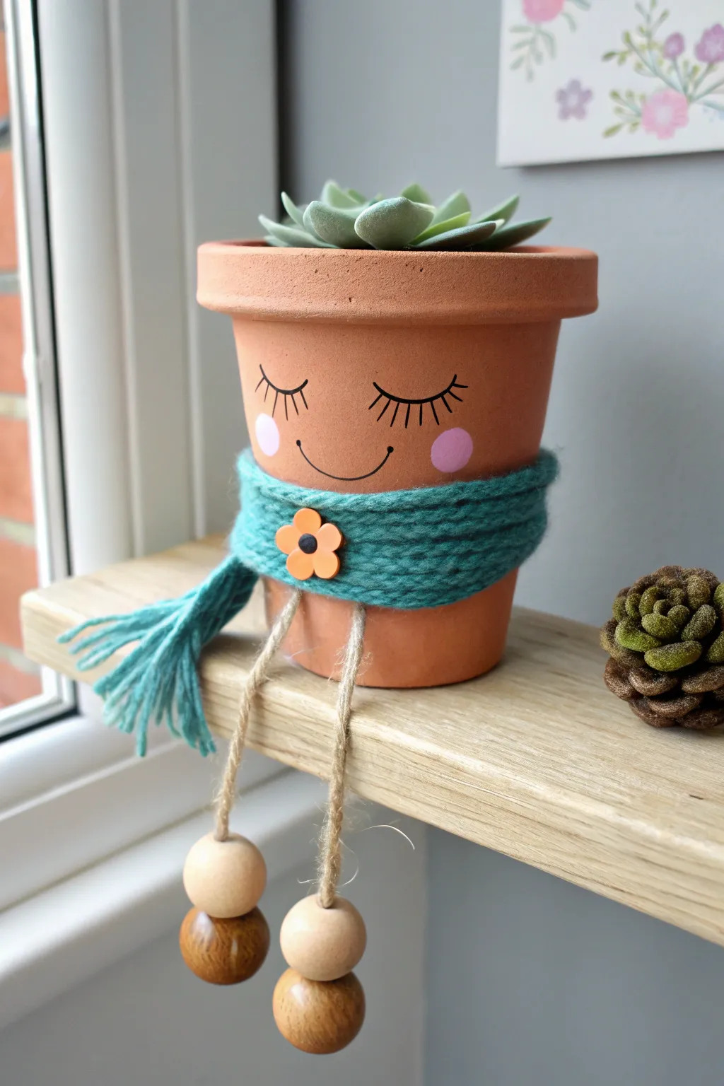 Mini terracotta pot person shelf sitter with a painted face and felt scarf, cozy boho minimal.