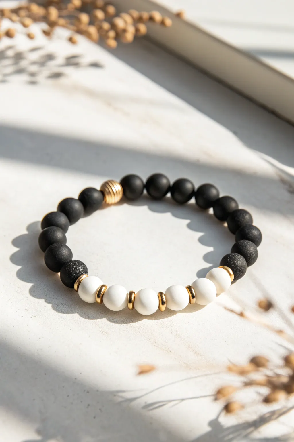Black-and-white clay bead bracelet with tiny metallic accents for a bold neutral look