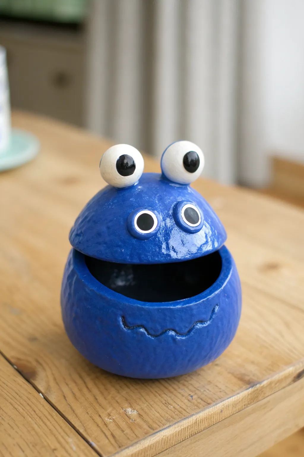 Bright blue pinch pot monster with goofy bug eyes on stalks, bold and beginner friendly