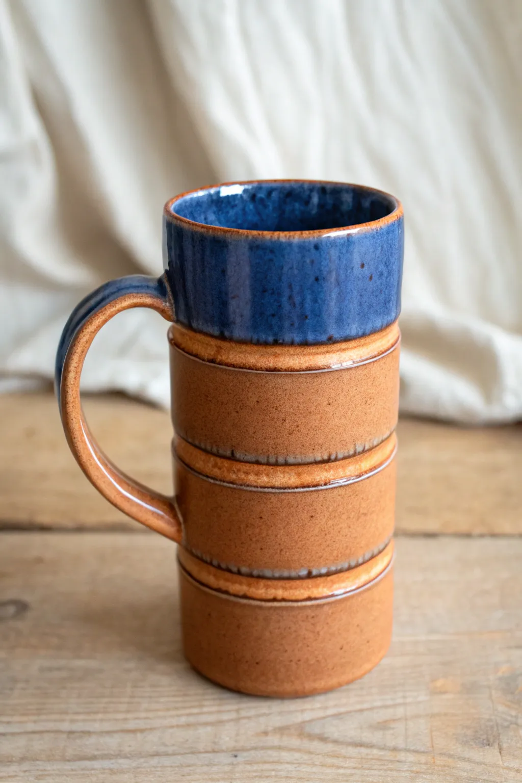 Tall stacked pinch pot mug with a subtle seam and bold cobalt glaze, minimal yet handmade.