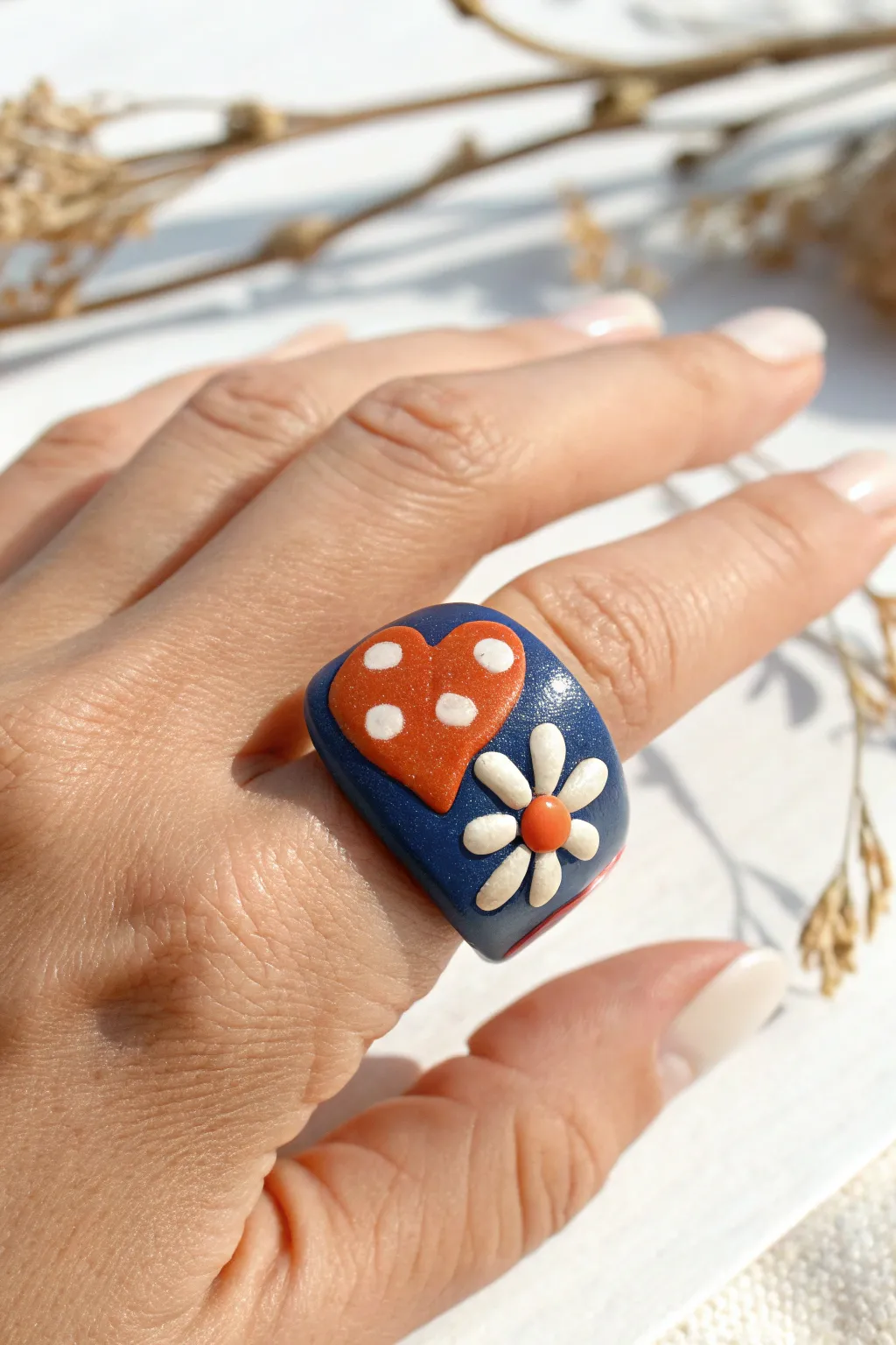 Chunky polymer clay statement ring with playful sculpted shapes in bold boho colors.