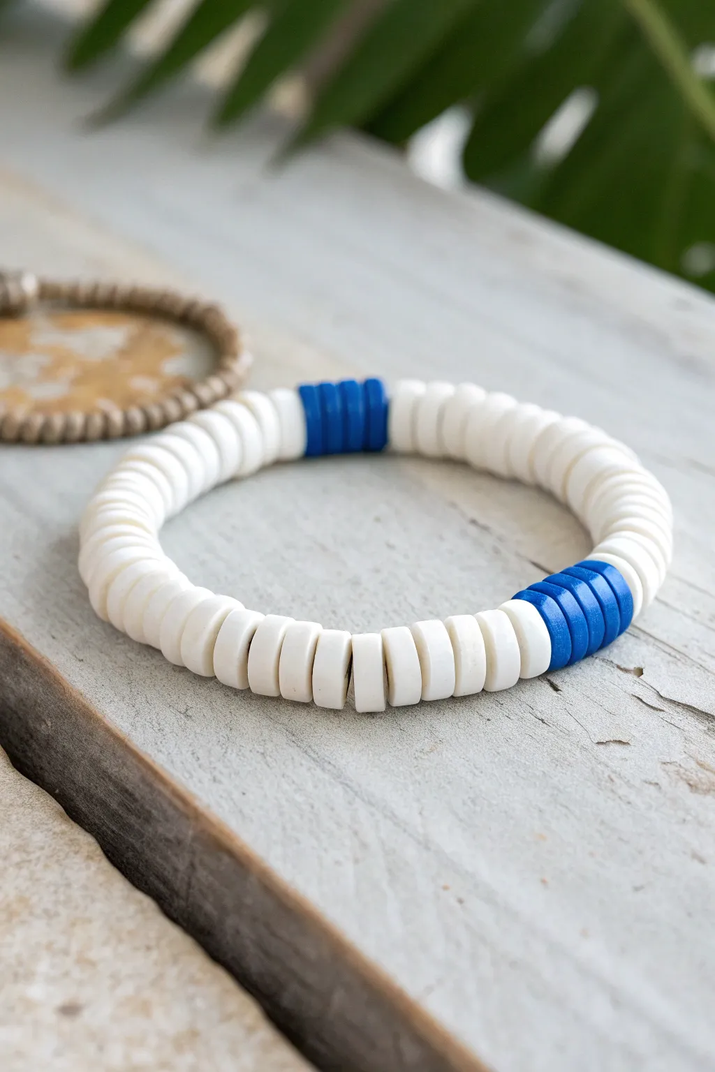 Minimal white heishi bracelet with one bold cobalt stripe for a clean, handmade pop of color.