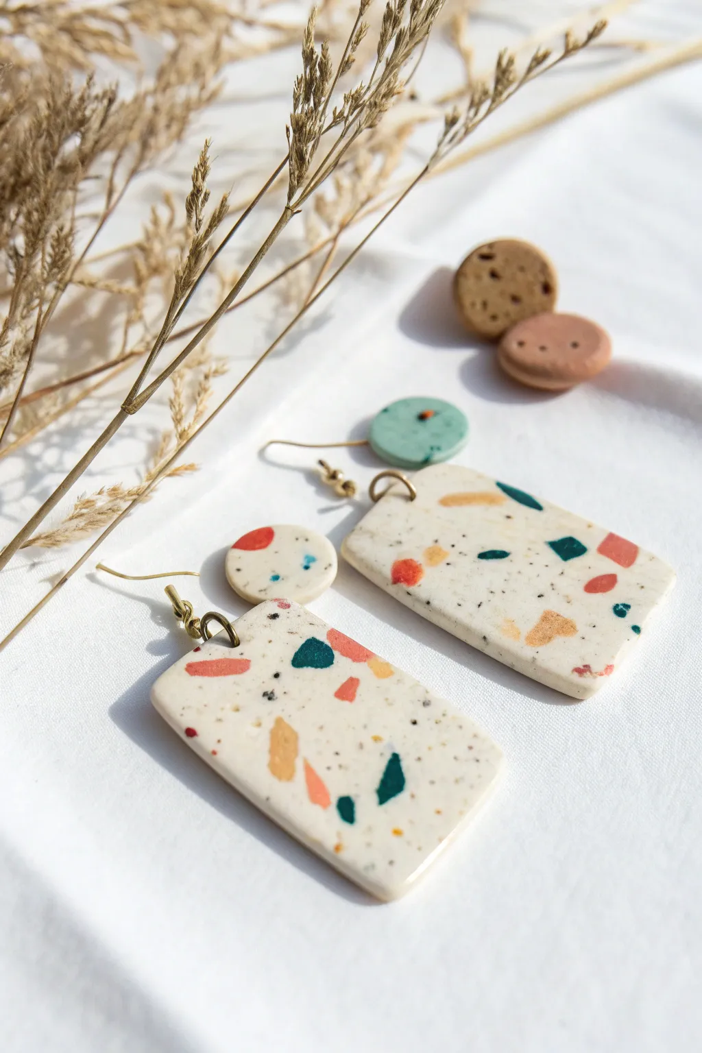 Terrazzo speckle polymer clay dangles in a creamy base with bold, colorful confetti pops.