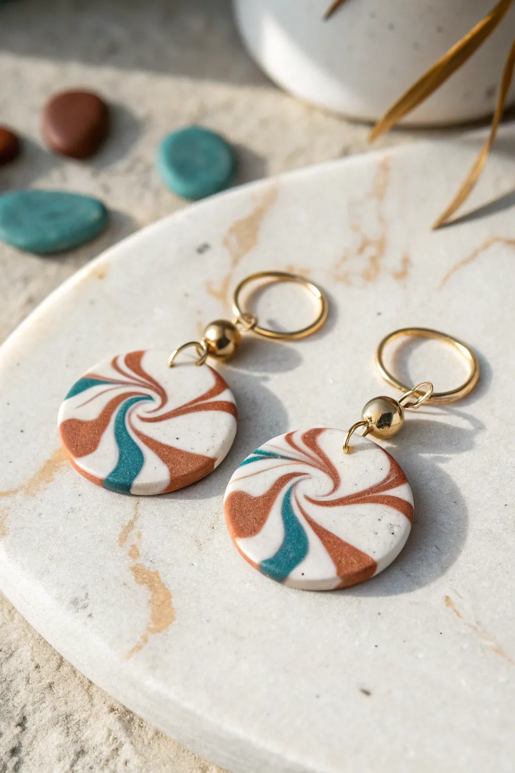 Fancy fast marbled kidney earrings in white, terracotta, and teal for an easy chic look