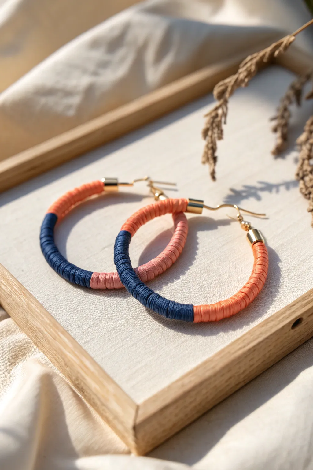 Ombre extruded-clay hoop earrings with a seamless dark-to-light wrap in soft natural light.