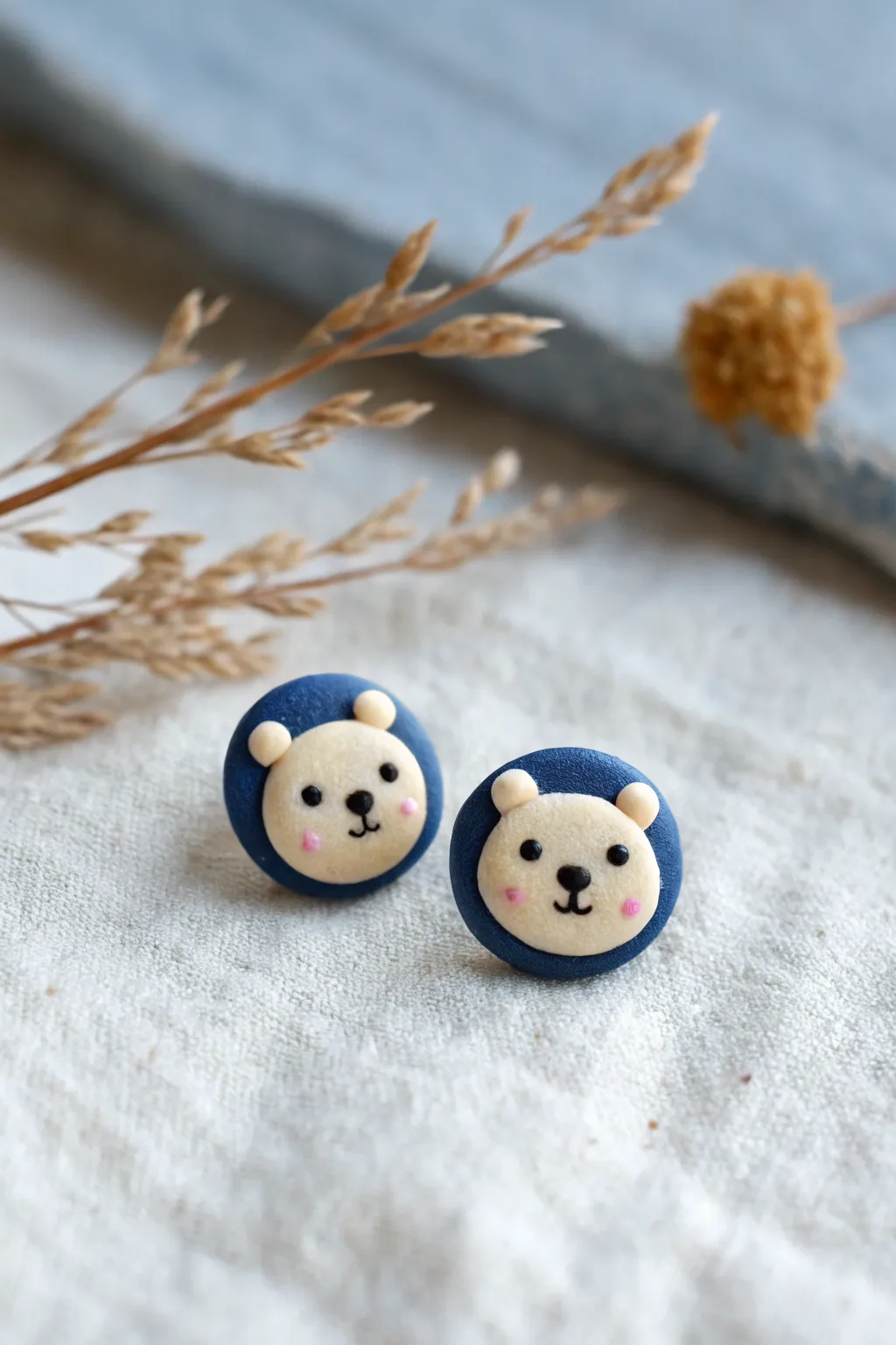 Tiny teddy bear face studs in bright clay tones, minimalist and irresistibly cute.
