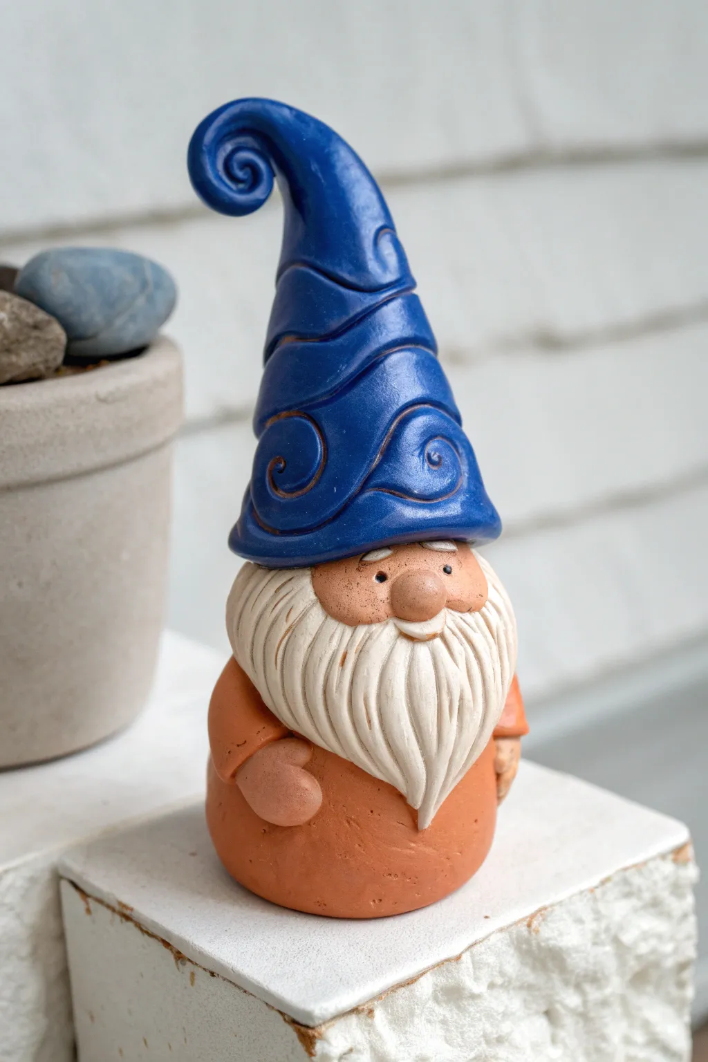 Twisted-hat pottery gnome with bold cobalt glaze and a textured beard for cozy modern decor.