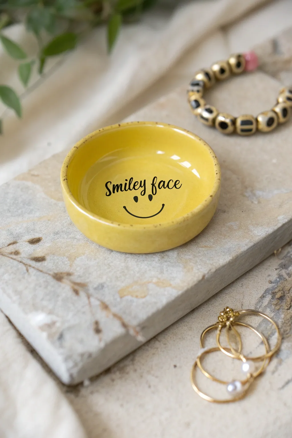 Preppy smiley catchall dish in buttery yellow, perfect for rings and clips on your vanity
