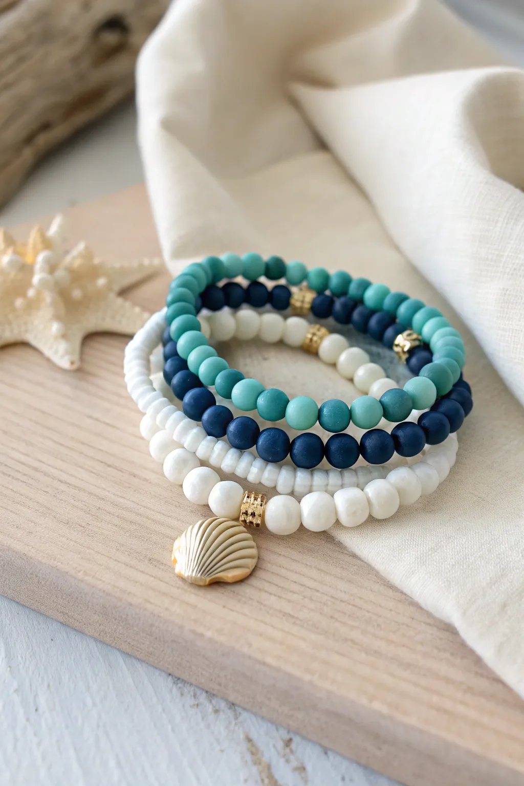 Ocean-tone preppy clay bead bracelet stack with a tiny shell charm for breezy coastal vibes