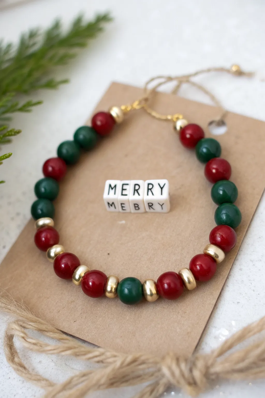 Preppy Christmas bracelet with MERRY alphabet beads, red and green clay, and gold accents.
