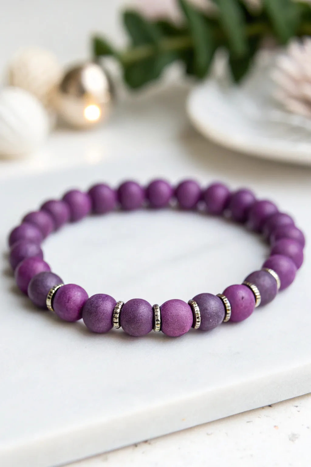Minimal purple clay bead bracelet with gleaming metallic spacers for an elevated handmade look.