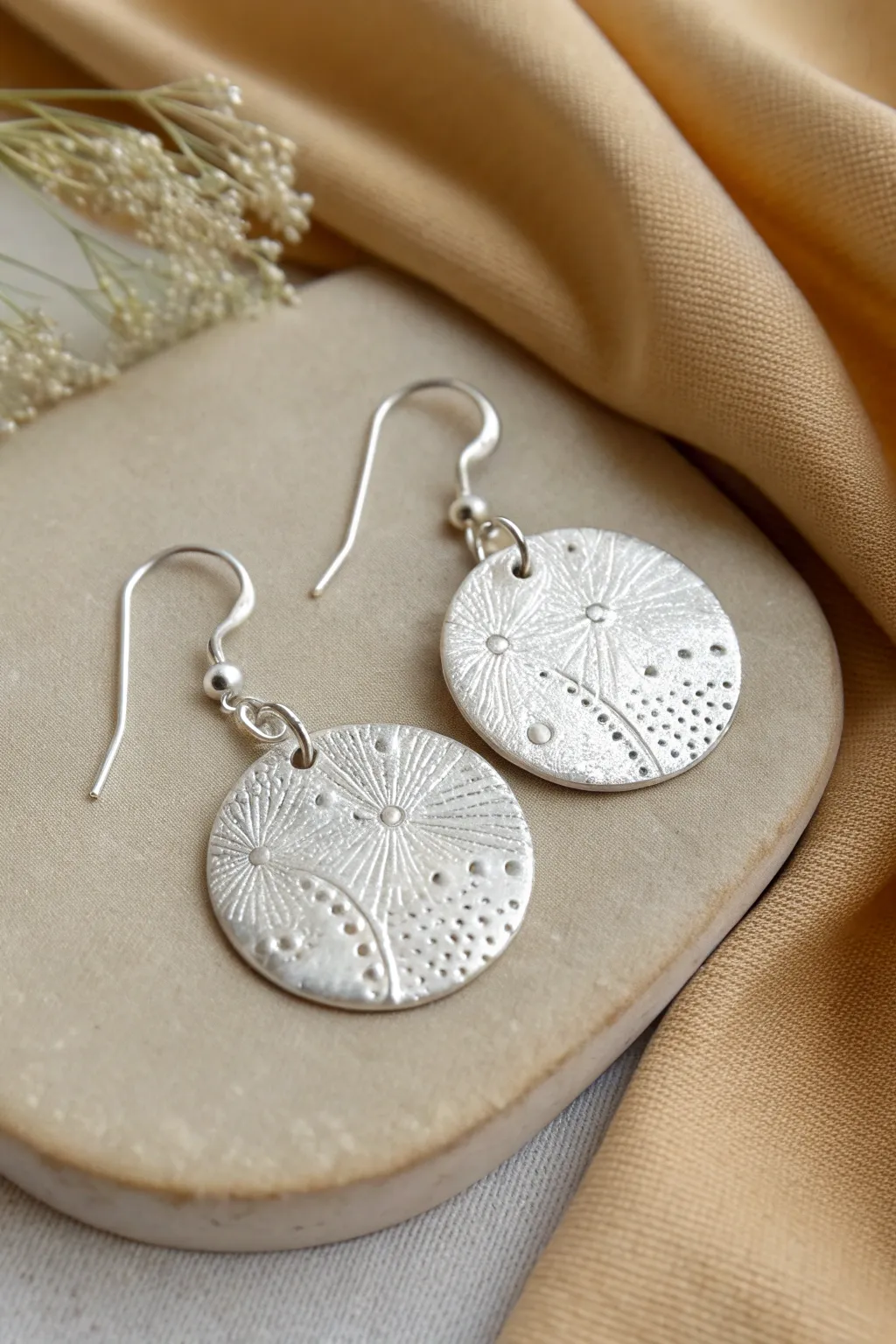 Textured silver clay disc drop earrings in minimalist Nordic style, bold yet handmade and simple.
