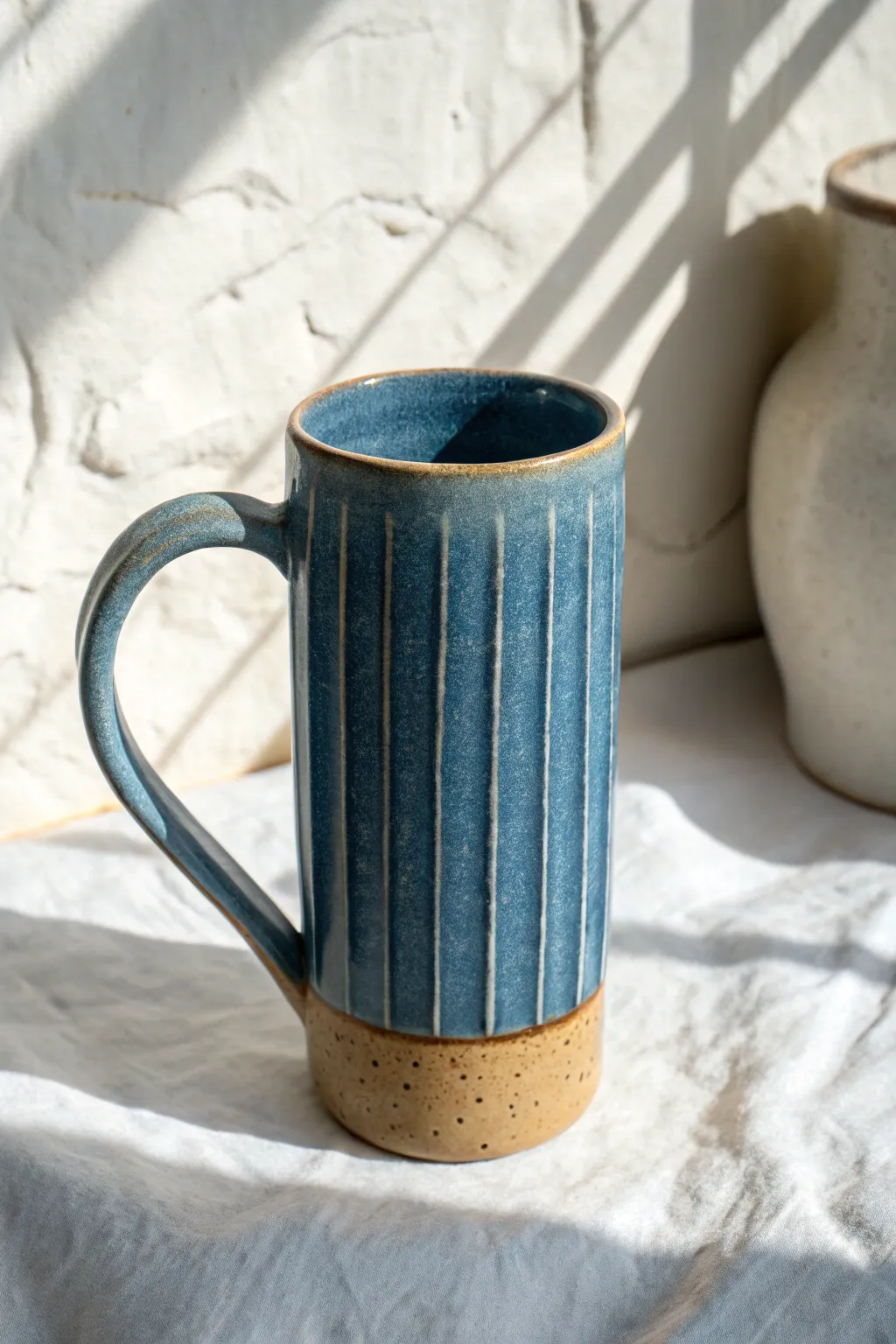 Tall tapered slab mug in bold matte glaze, minimalist and handmade with a cozy grip.
