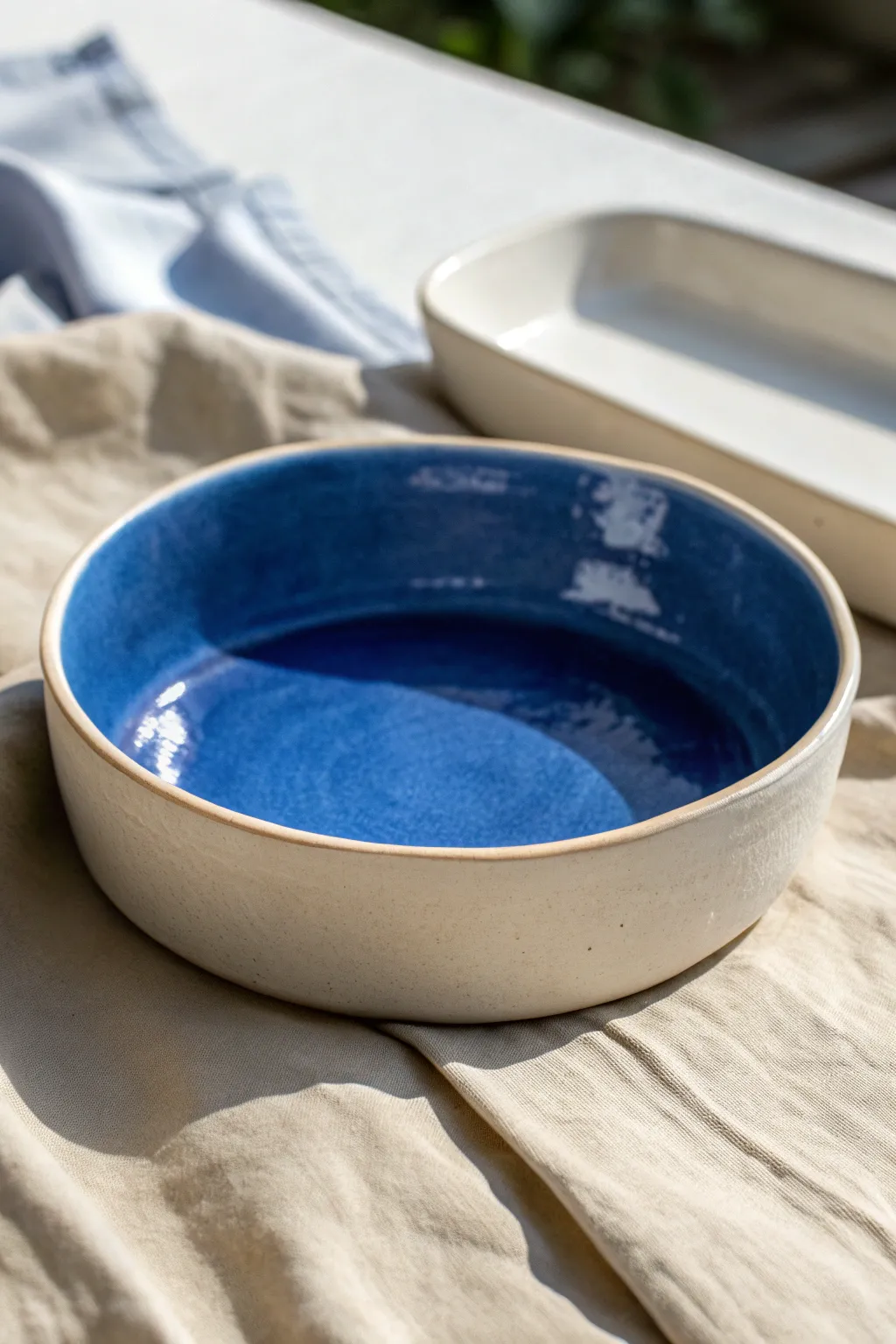 Soft slump-molded tray-bowl hybrid in bold glaze, minimalist curves for modern slabs.