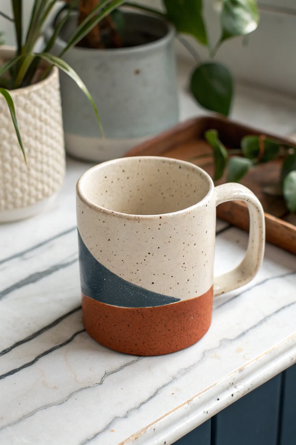 Squarish soft slab mug with rounded corners and a bold dipped glaze band, calm and modern.