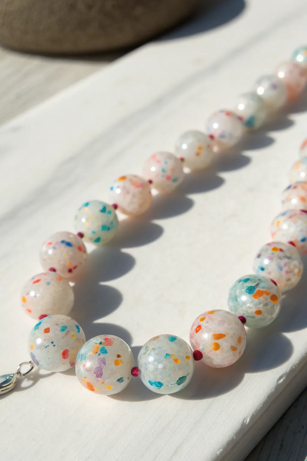 Opal-like translucent beads with floating confetti flecks, glossy, minimal, and beautifully handmade.