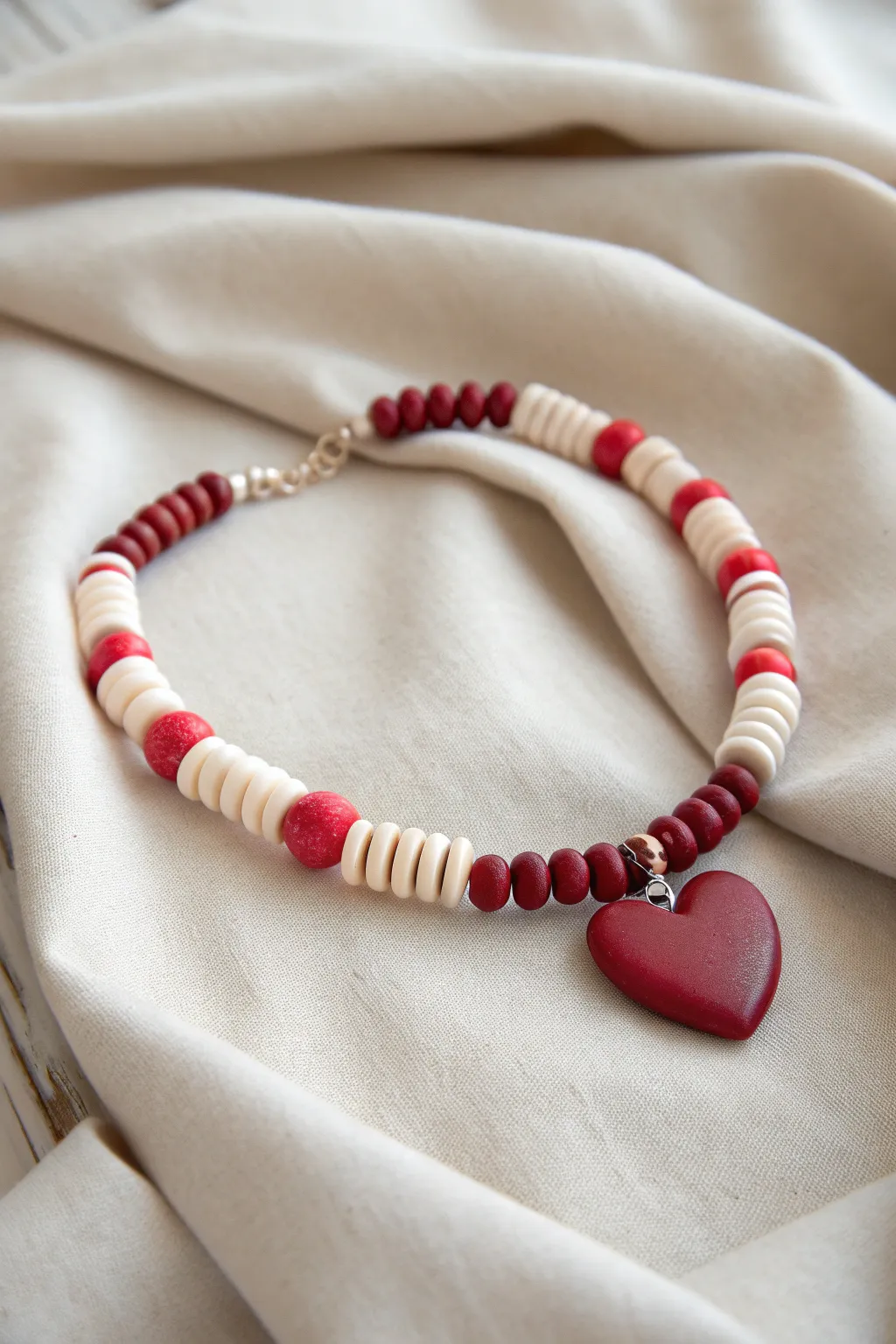 Minimal red and white heishi bracelet with a bold clay heart focal, perfect for Valentines gifting