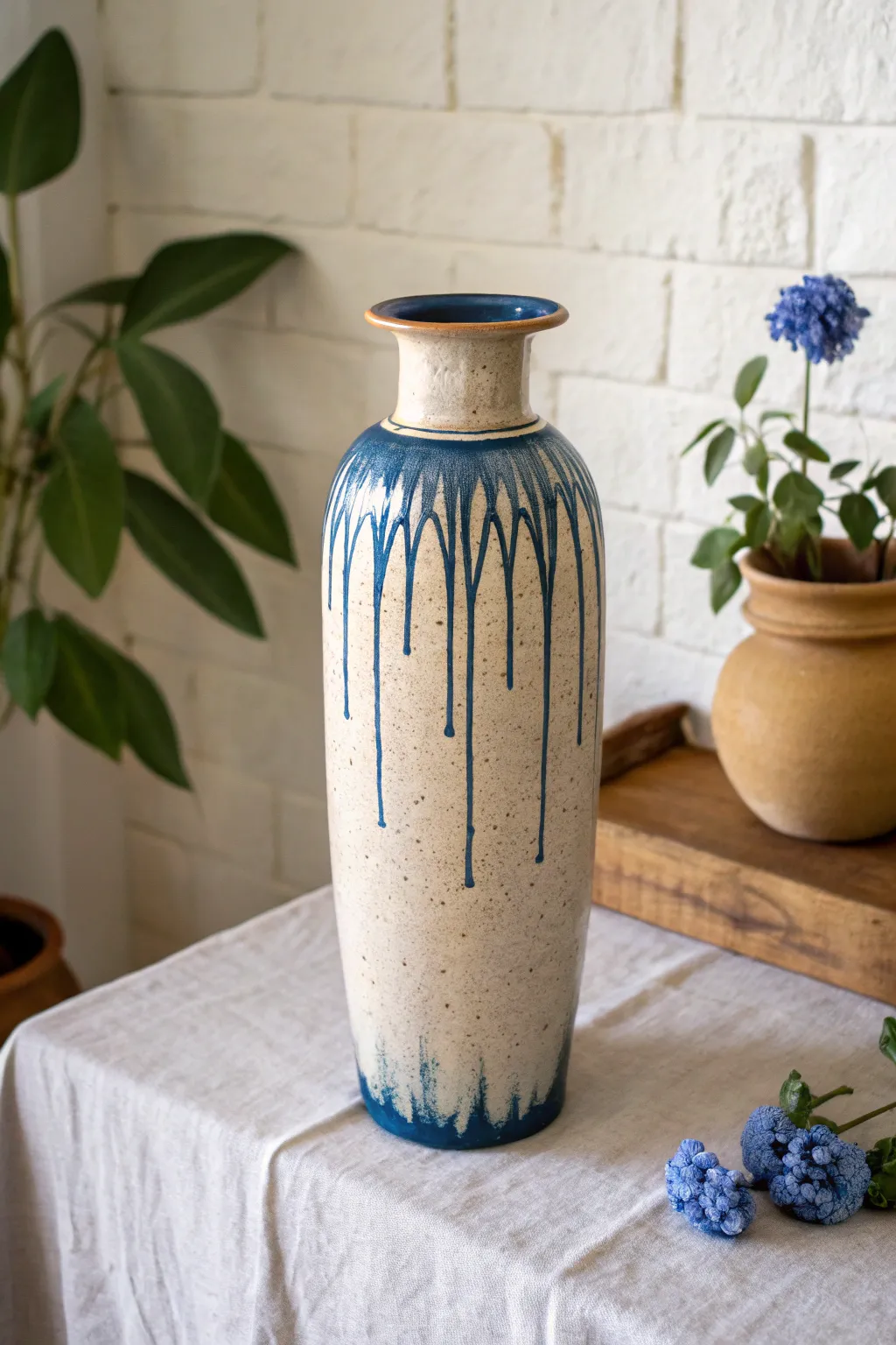 Tall waterfall-glaze vase with bold drips, minimalist styling, and handcrafted charm.