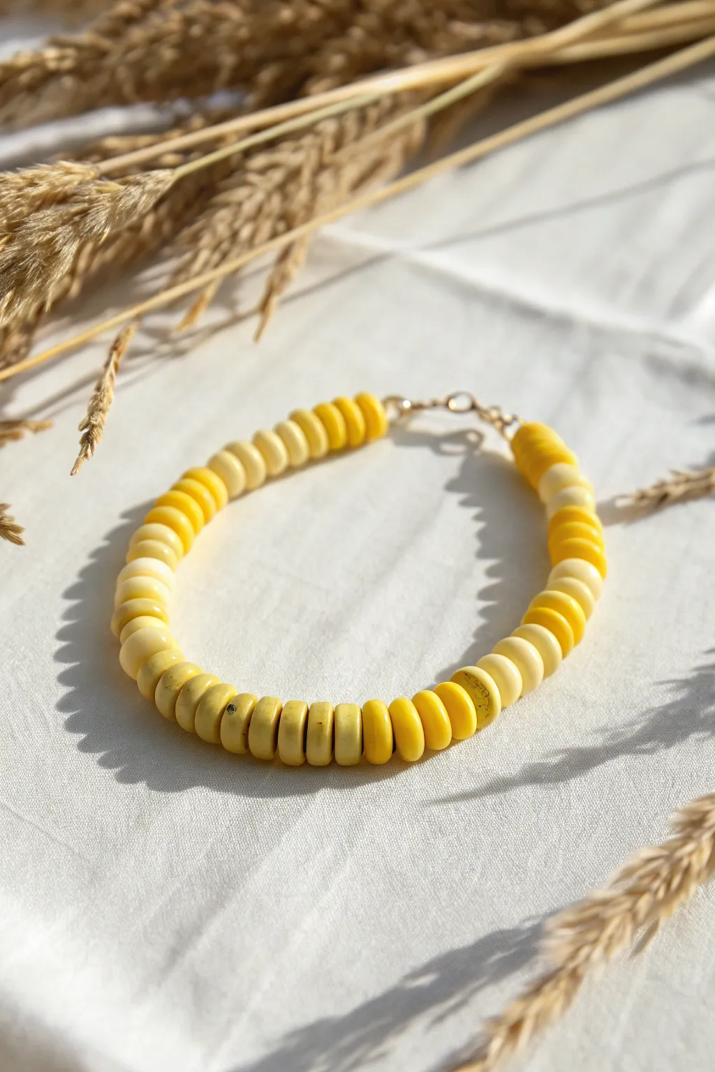 Sunshine ombre bracelet in buttery-to-lemon yellow clay discs, minimal and bold.
