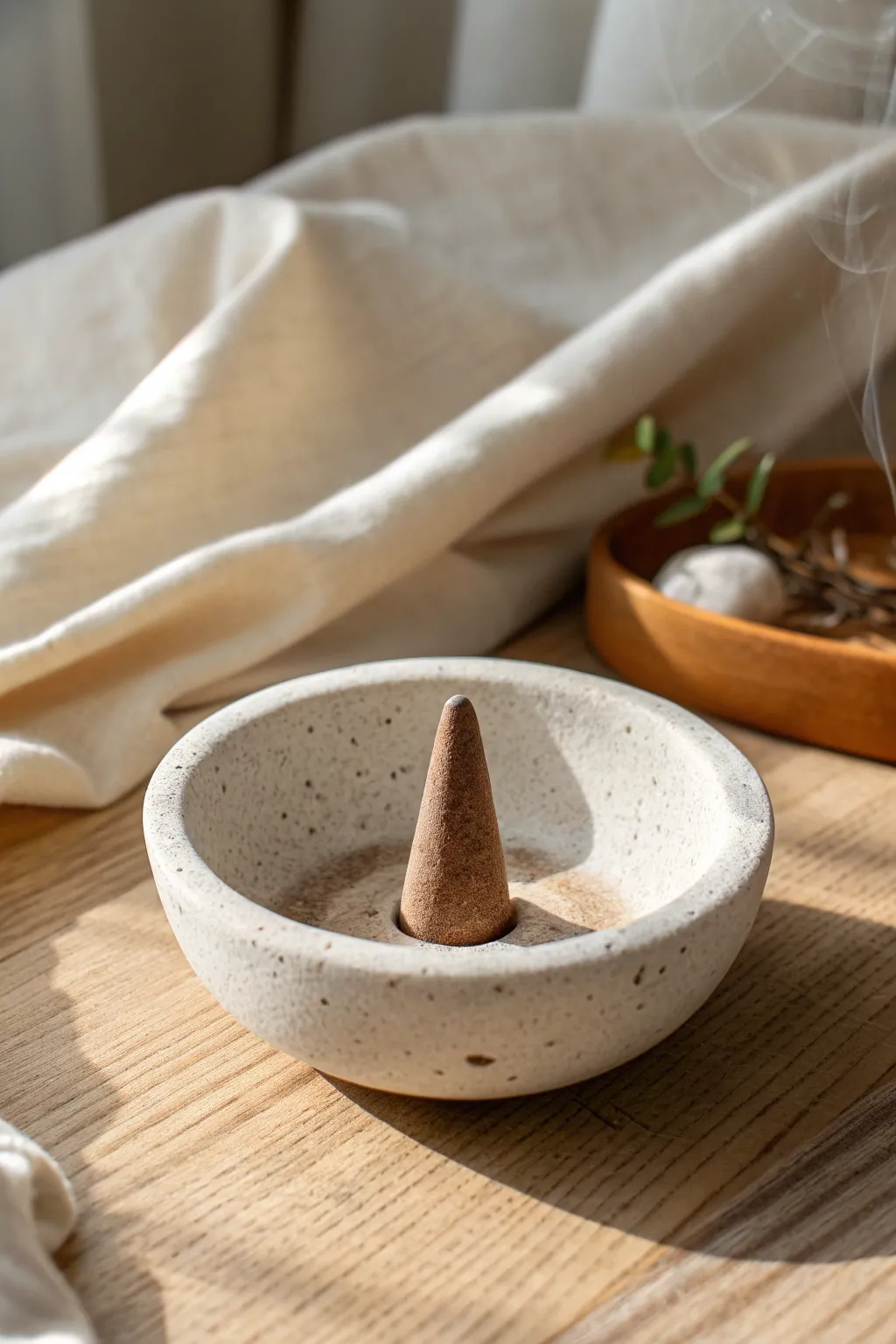 Minimal pinch pot cone burner in matte clay, keeping incense ash neatly contained