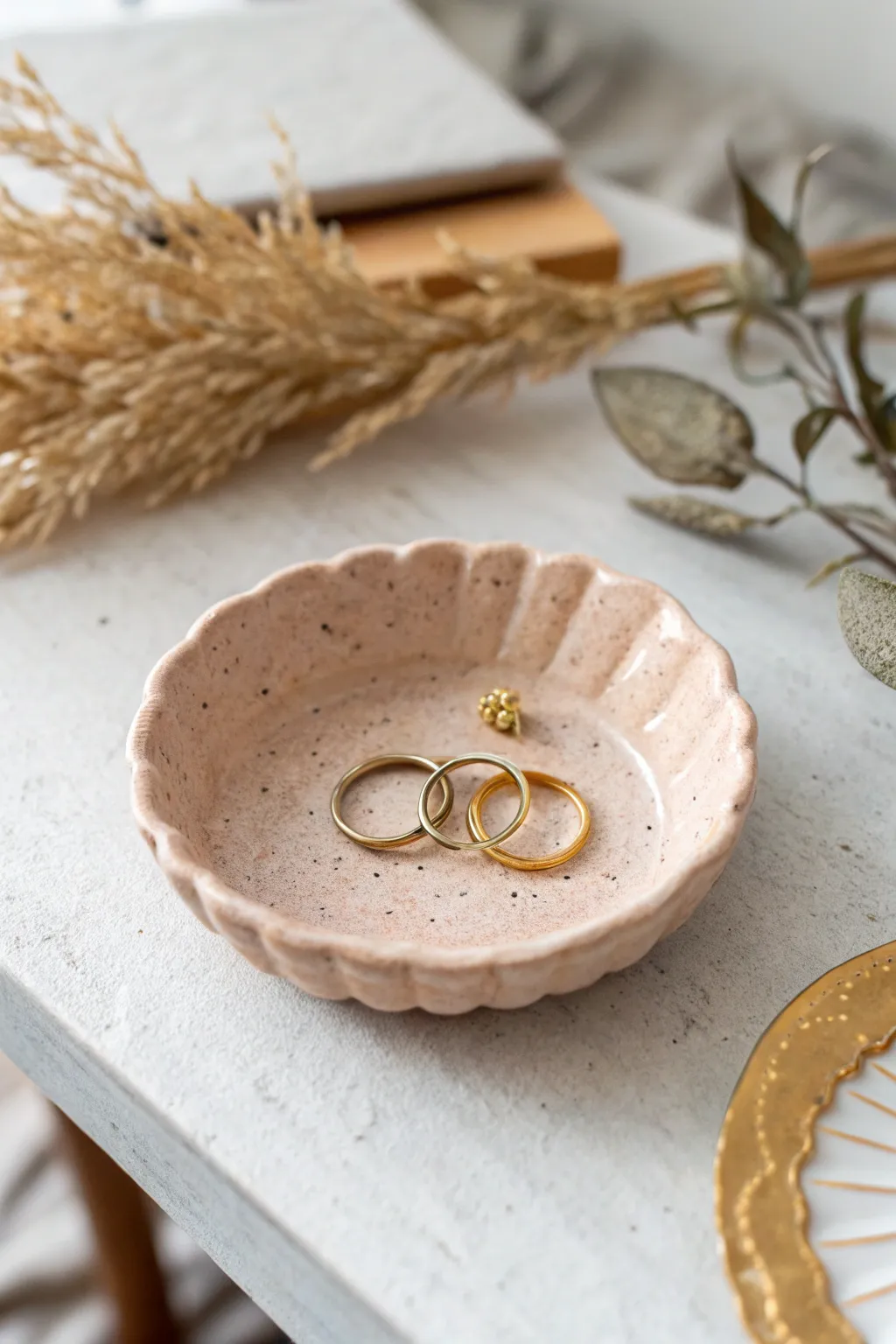 Scalloped air-dry clay dish in soft neutrals, perfect for rings and tiny studs.