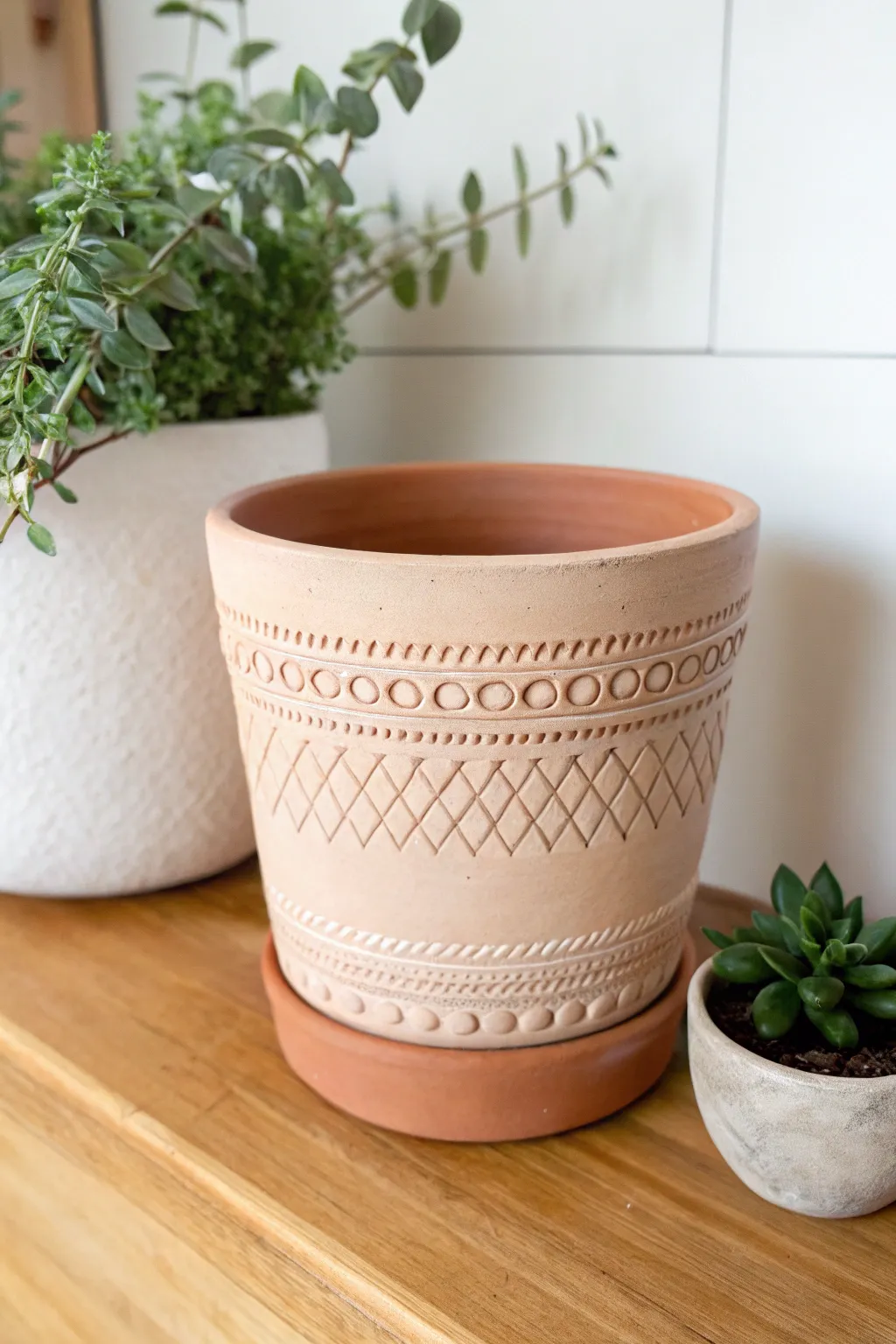 Stamped texture air-dry clay pot with a simple solid finish, styled with a small air plant.