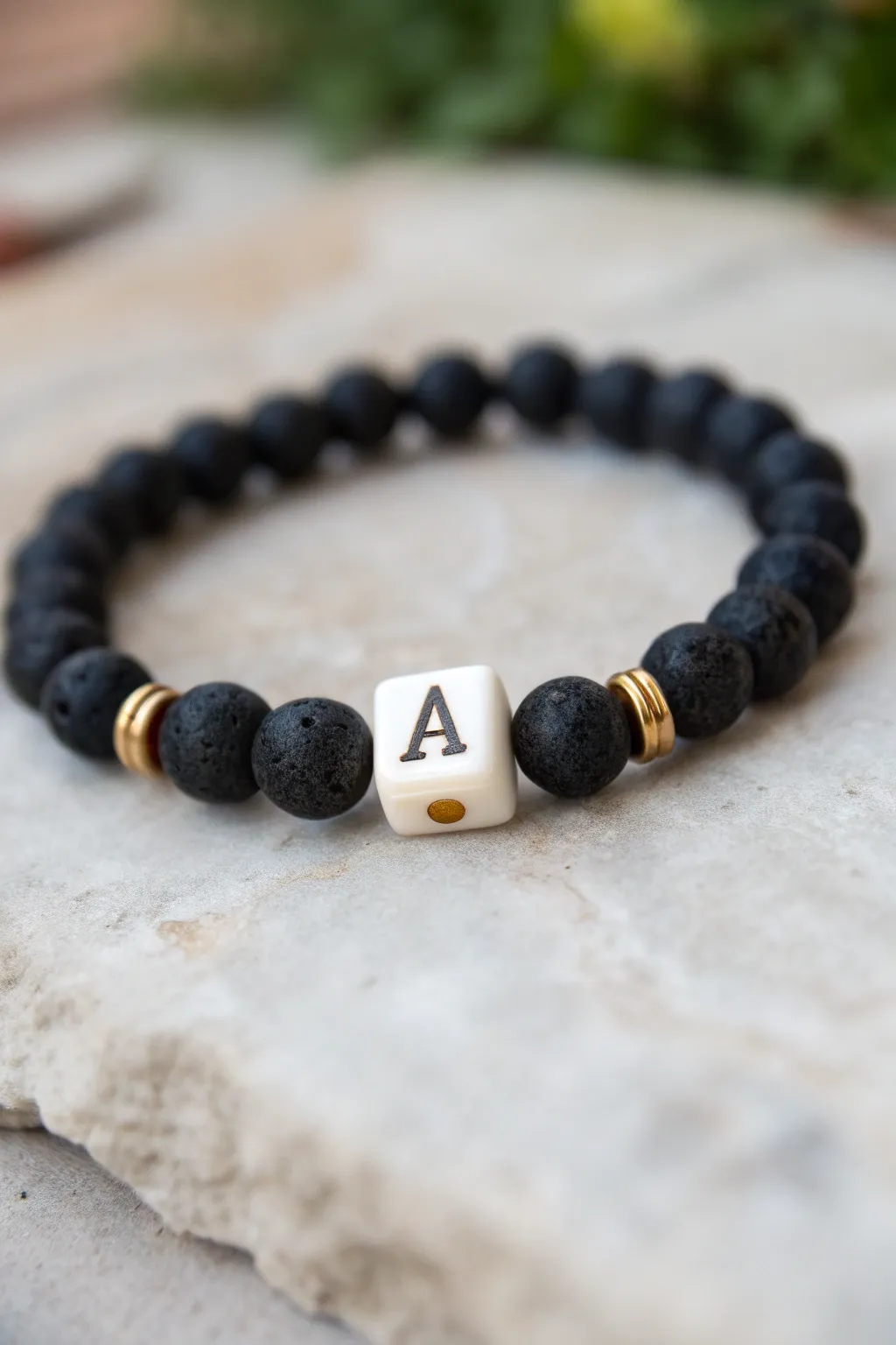 Minimal black clay bead bracelet with one centered initial for a clean, modern handmade look.