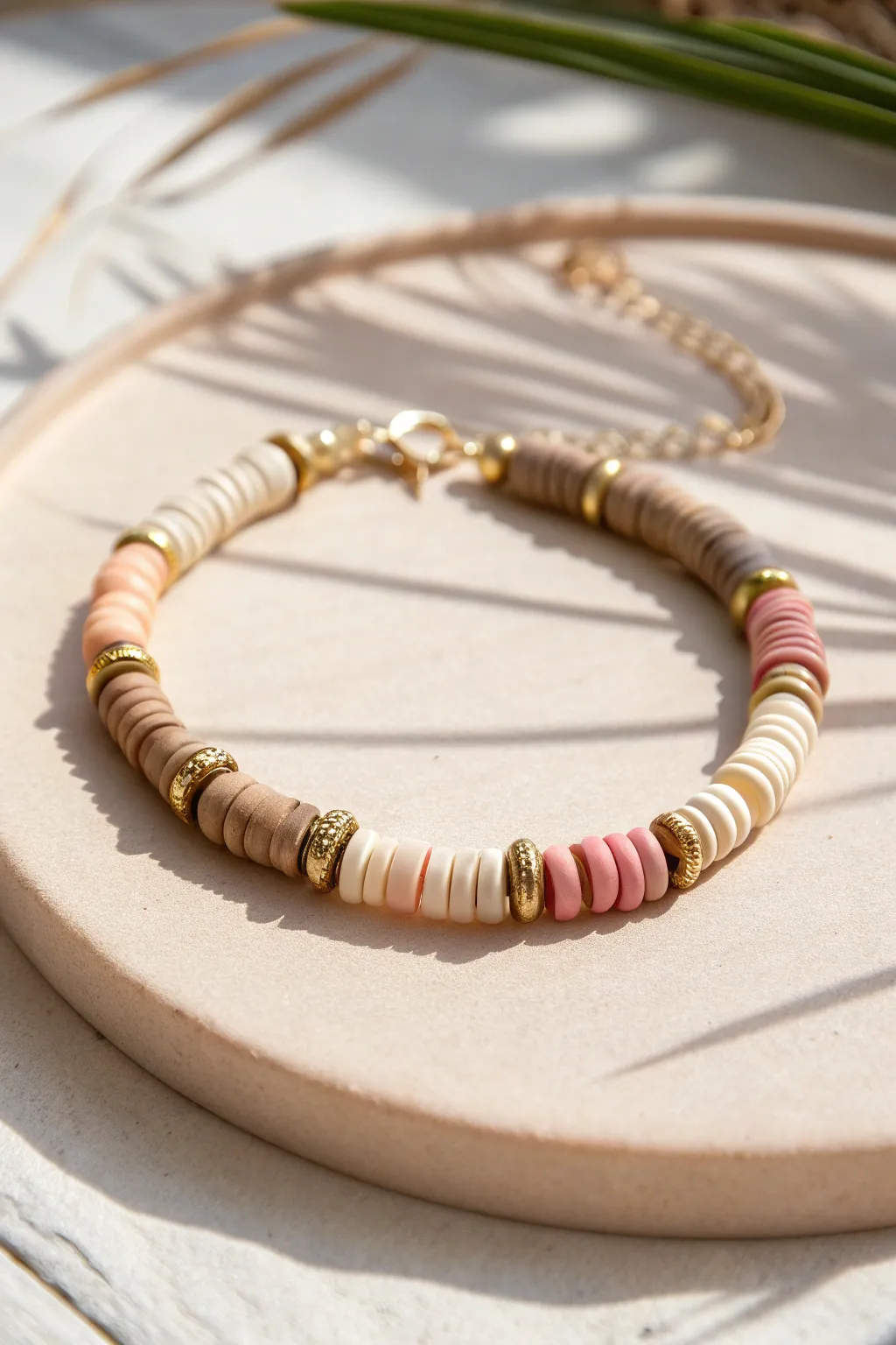 Minimal heishi bracelet with shiny gold spacer rhythm for an effortless modern boho look.