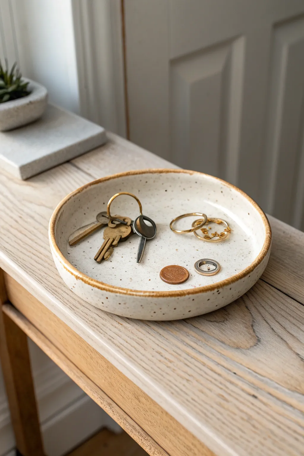 A handmade speckled ceramic catchall tray that keeps keys, coins, and rings in style.