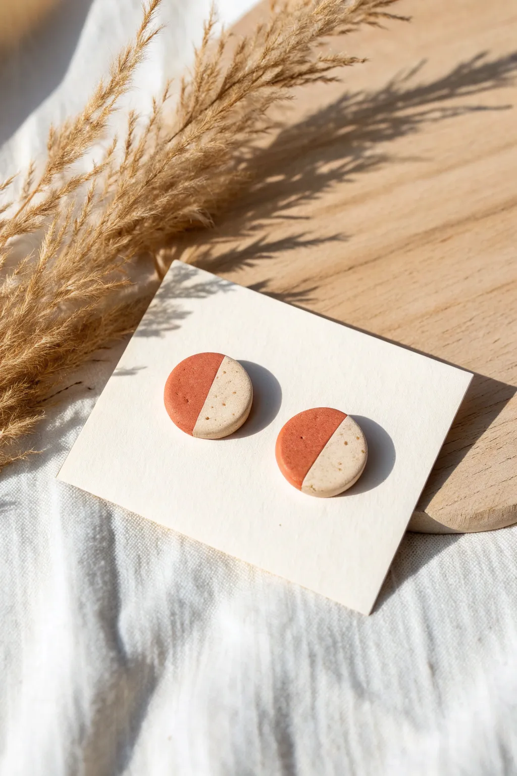 Minimalist polymer clay circle stud earrings with subtle speckles, styled for calm boho vibes.