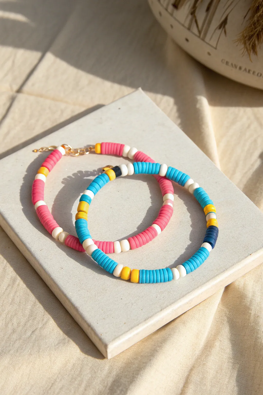 Preppy bright color block clay bead bracelets with crisp white heishi stripes, styled for selling.