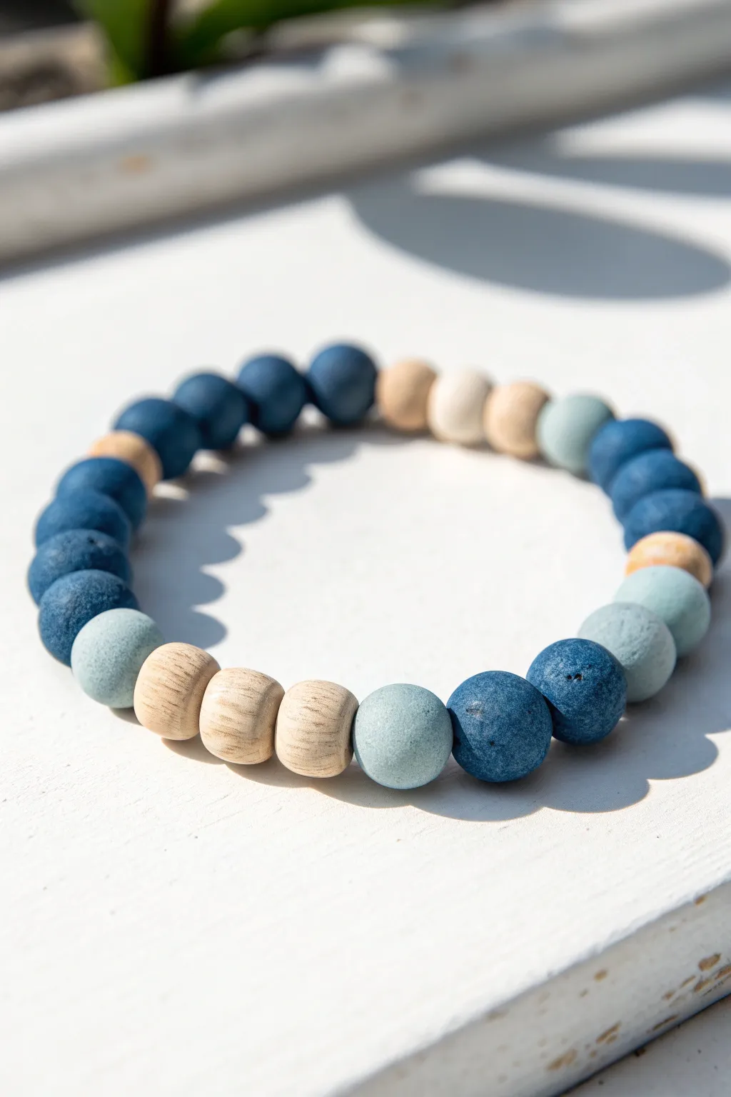 Soft ombré clay bead bracelet fading from deep to pale blue for a calm, modern look.