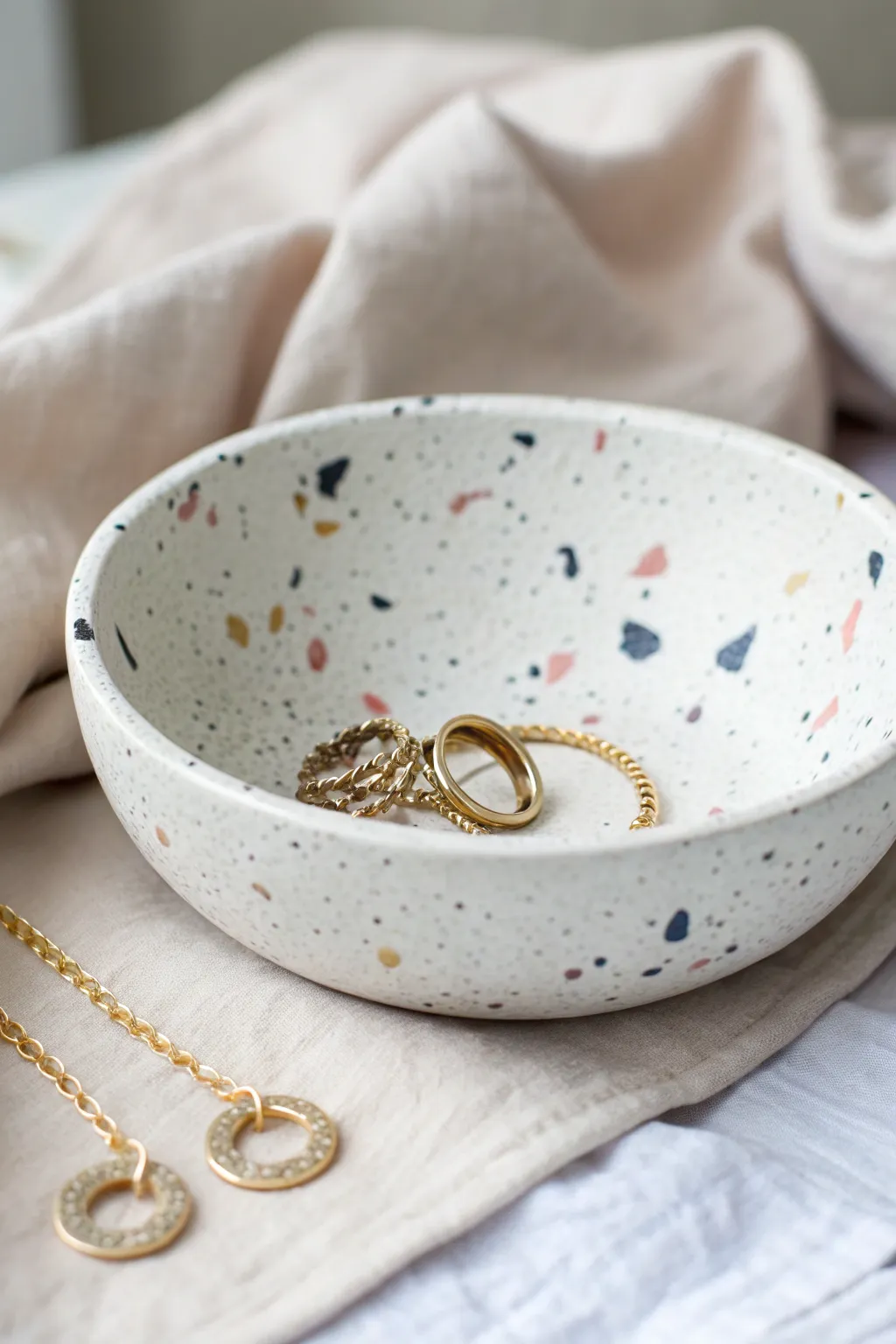 Speckled terrazzo-style air-dry clay bowl, styled as a chic ring dish with minimal boho vibes.