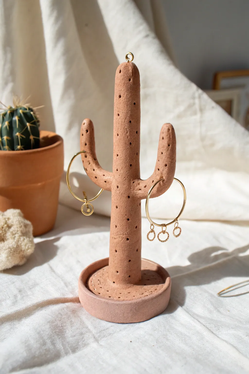 Playful minimalist cactus holder with hoops and studs, a sweet clay DIY for your dresser.